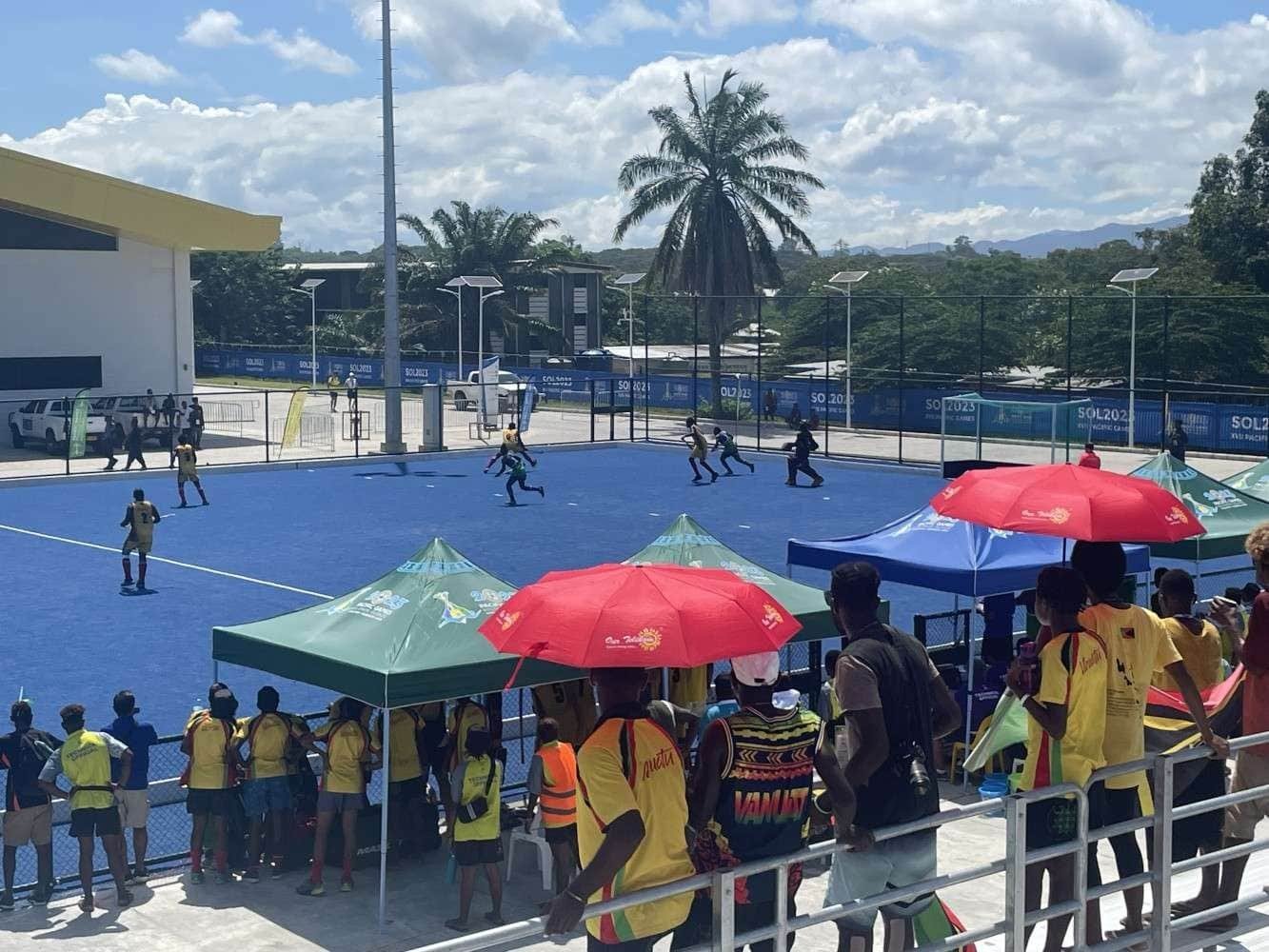 oceania pacific games great crowds 657817828eee8 - Oceania: Pacific Games Great Crowds - Hockey5s is a very short version of the game with 2x 10 minutes halves, lots of action and shots on goal. The fact that the 2 Solomons Islands teams were performing well encouraged the crowd to fill the stands but as the competition in both women and men's pools were close there were plenty of Fijian, Samoan, Tongan, Papua New Guinea and Vanuatu supporters to add to the banter. Music was played while the teams warmed up, at half time and to celebrate a goal! This kept the crowd rocking! The fact that the athletes main Food Hall was just past the hockey venue created extra promotion for hockey and as the matches reached the semi finals and finals many athletes collected their food and came outside to watch and cheer on their team mates.
