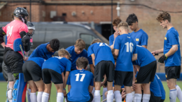 Talent Academy players, boys, Huddling, wearing blue