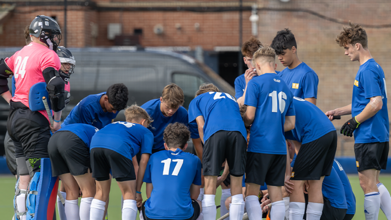 Talent Academy players, boys, Huddling, wearing blue